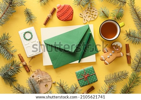 Composition with envelope, cup of tea, cookies and fir branches on color background