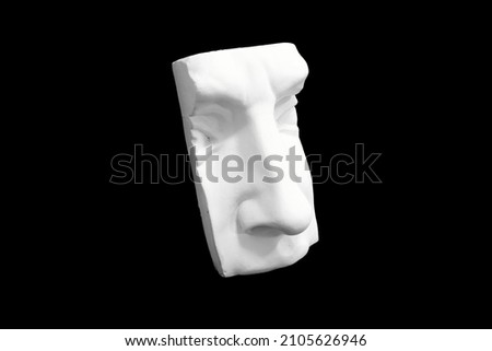 Fragment of plaster sculpture of a human face isolated on black background. High quality photo Royalty-Free Stock Photo #2105626946