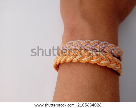 asian girl wearing bracelet craft from rope on white background