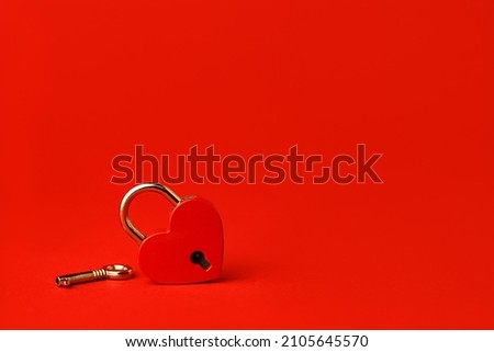 Heart lock with key. Red background. February 14 and Valentine's Day. Love and relationships concept. Romance and recognition.