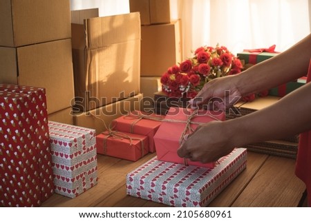 business owner working, packing the order for shipping to customer. male entrepreneur packaging box for delivery. Online shopping e-commerce and logistic shipping freight transportation. sealing box. Royalty-Free Stock Photo #2105680961