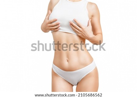 Plastic surgery, abdominoplasty, dieting, wellness, health. Female slim body in base underwear isolated on white, close up. Female fit torso in white panties and top, isolated on white.