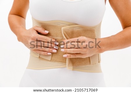 Orthopedic lumbar corset on the human body. Back brace, waist support belt for back. Posture Corrector For Back Clavicle Spine. Post-operative Hernia Pregnant and Postnatal Lumbar brace after surgery. Royalty-Free Stock Photo #2105717069