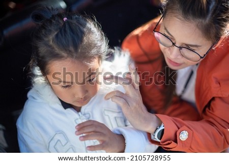 Asian mother and child in winter clothes with copy space.