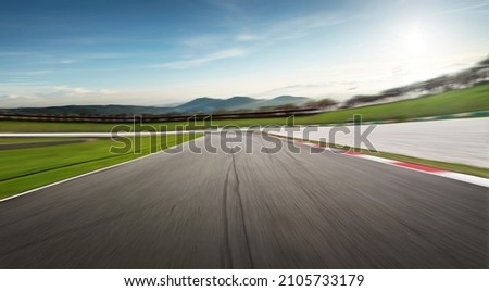 Curvy motion blurred race track. Royalty-Free Stock Photo #2105733179