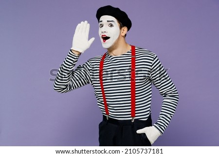 Young mime man with white face mask wears striped shirt beret scream hot news about sales discount with hands near mouth look camera isolated on plain pastel light violet background studio portrait Royalty-Free Stock Photo #2105737181