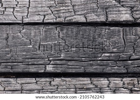 Beautiful wooden background consisting of three boards with a beautiful texture of burnt wood.