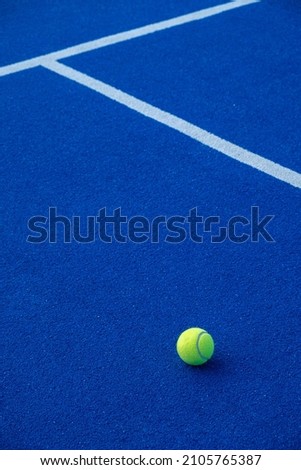 Paddle tennis ball on a blue paddle tennis court. Racket sports Royalty-Free Stock Photo #2105765387