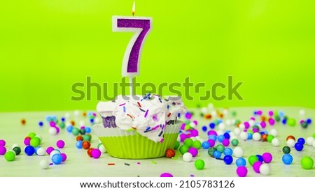 Beautiful birthday greetings to a seven-year-old child on a green background, a postcard for 7 years happy birthday copy space. Festive children's background with cream cake