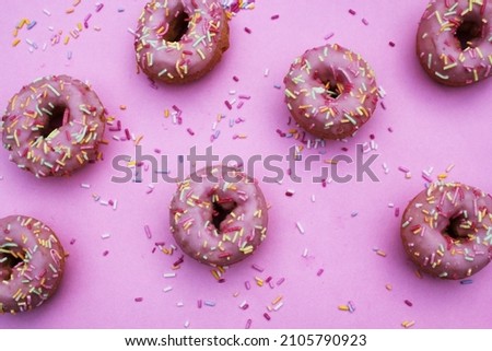 pink donut donuts sprinkles on doughnuts pink bright glazed frosting sugar strands repeat pattern background