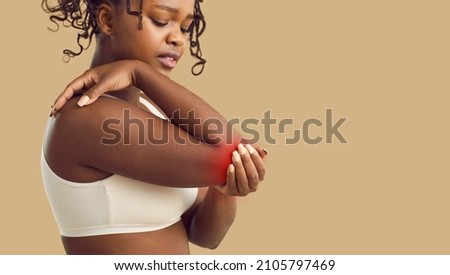 Unhealthy young African American woman struggle with ache in arm. Pain in elbow or cubit. Unwell sick black ethnic female suffer from inflammation in hand, have arthritis. Healthcare and medicine. Royalty-Free Stock Photo #2105797469