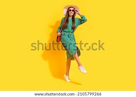 Full body photo of cool mature brunette lady dance wear cap dress footwear bag eyewear isolated on yellow color background