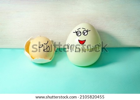 Funny scene - mother egg gave birth to a baby yolk. Cesarean section, childbirth. Mother's Day. Easter.