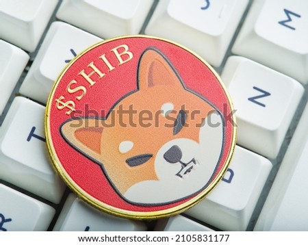 White keyboard of a personal computer, laptop. Shibu ina coin is a cryptocurrency. Cryptocurrency mining, crypto farm. New financial technologies, virtual money, risk, cash flows.