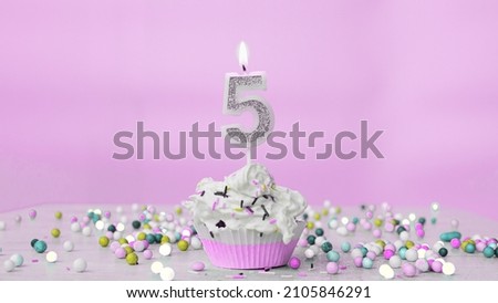 Beautiful birthday greetings to a five-year-old child on a pastel pink background, postcard for 5 years happy birthday copy space. Festive background with creamy cupcake