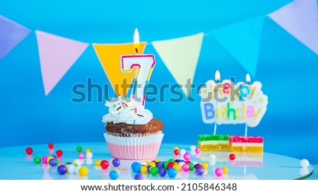Beautiful birthday greetings to a seven year old child on a blue background, a card with the number 7 years happy birthday copy space. Background with festive decorations for a small child