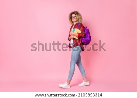 Photo of tourist lady walk study abroad concept wear glasses checkered shirt jeans isolated pink color background