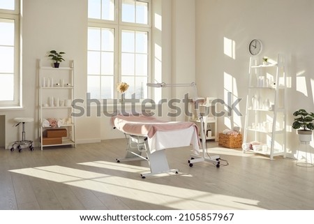 Bright empty cosmetology cabinet in modern beauty clinic. Interior of beautician room in aesthetic medicine salon. Medical office of dermatologist specialist. Cosmetic, skincare saloon treatment. Royalty-Free Stock Photo #2105857967
