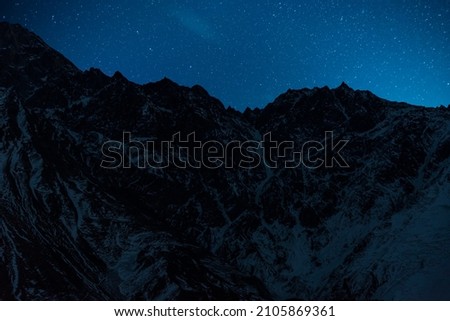 Beautiful winter mountains landscape in the starry nigh. High snow covered. Georgia, Kazbegi.