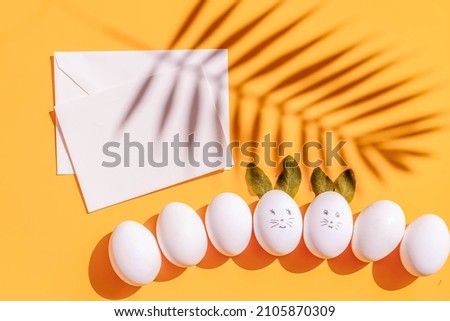 Easter scene with white eggs over illuminating yellow background, Plam Sunday - Easter Holiday concept