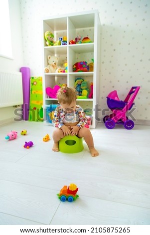The child is sitting on the potty. Selective focus. Baby.