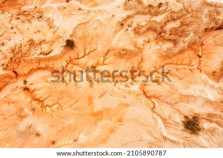 Eroded dry lake Mungo bed in Australian outback national park - sandstone and clay formation after wind and water erosion in aerial top down view.