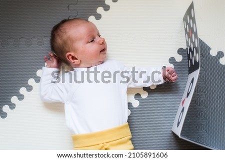 baby looking at black and white contrast book