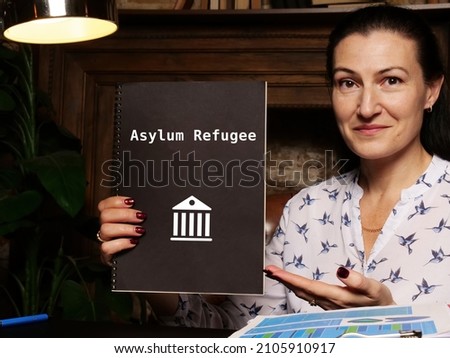  Juridical concept meaning Asylum Refugee with sign on the sheet.
 Royalty-Free Stock Photo #2105910917