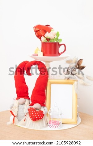 Gnomes and mock-up photo frame and red cup for text for Valentines Day home decoration