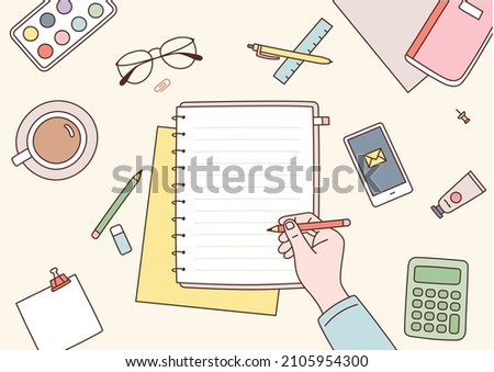 A desk untidy with office supplies. A hand is writing something on a notebook. flat design style vector illustration.