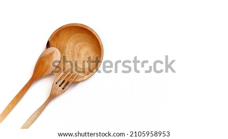 Wooden kitchenware that gives a classic and minimalist impression. Food and drink concept. Food Photography. Flat Lay Wooden spoon and fork on the table. White Background. Copy space. Space for text. 