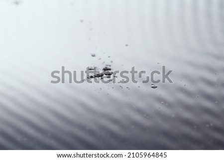 Dust particles on water surface