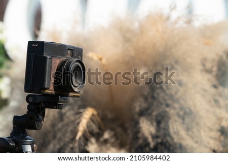 Old rusted camera with blurry background, photogenic concept, copy space, digital and analog world