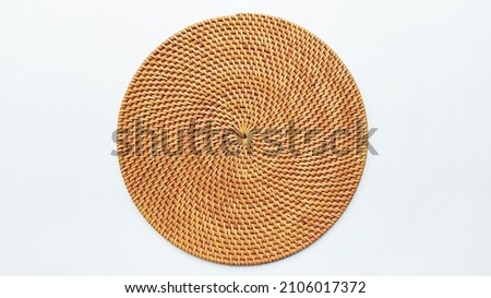 Rattan Round woven Placemat place on a white background. View from above Royalty-Free Stock Photo #2106017372