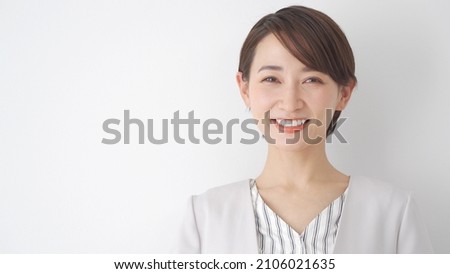 Asian woman looking at the camera with a smile
 Royalty-Free Stock Photo #2106021635