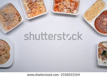 Overhead view several frozen meal on white background with copy space.