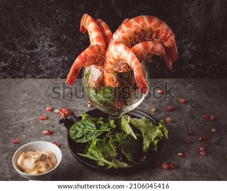 prawn cocktail with a bowl of sauce on a dark gray background. selective focus. copy space
