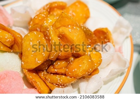 Chinese dessert sweet potato on the table Royalty-Free Stock Photo #2106083588