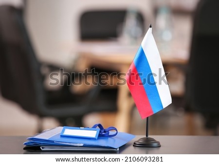 Russian flag with clipboards on table in conference room Royalty-Free Stock Photo #2106093281