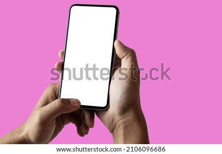Hand holding white mobile phone with blank white screen.