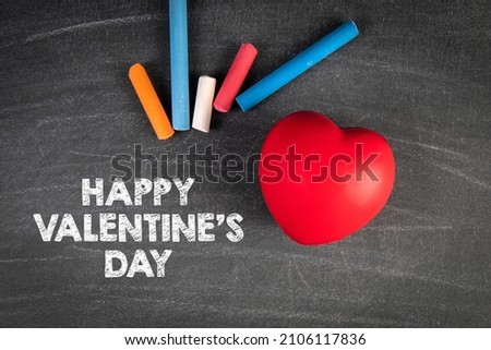 Happy Valentine's day. Red rubber heart on a chalk board.