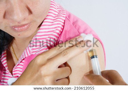 Doctor with syringe injection in the arm