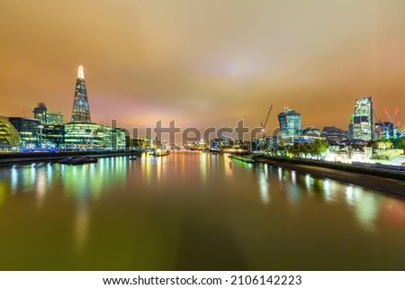 london by night river thames city hall reflections in water