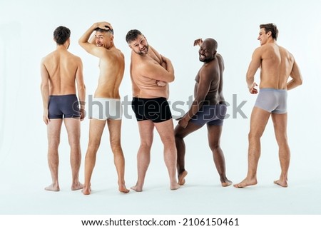 Group of multiethnic men posing for a male edition body positive beauty set. Shirtless guys with different age, and body wearing boxers underwear Royalty-Free Stock Photo #2106150461