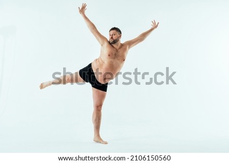 Man posing for a male edition body positive beauty set. Shirtless guy wearing boxers underwear in studio Royalty-Free Stock Photo #2106150560