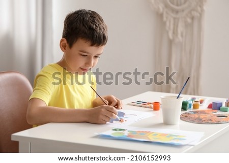 Little boy painting at home