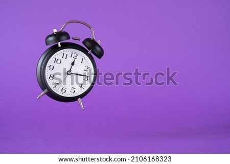 Retro levitation clock on purple background. Space for text.