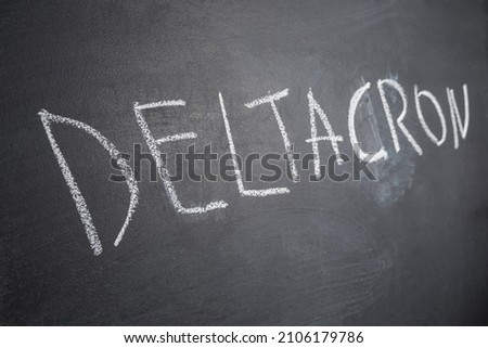 The Deltacron is a new combination version of the Delta variant and the Omicron variant written in chalk on a black board. COVID-19 Deltacron Variant Concept