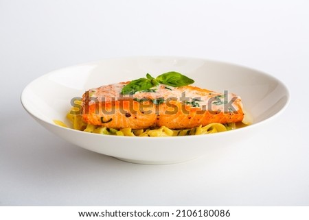 Baked salmon with noodles on plate Royalty-Free Stock Photo #2106180086