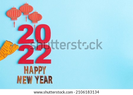 Chinese New Year, year of the tiger. Paper decoration with traditional motifs and tiger on blue background. Copy space.